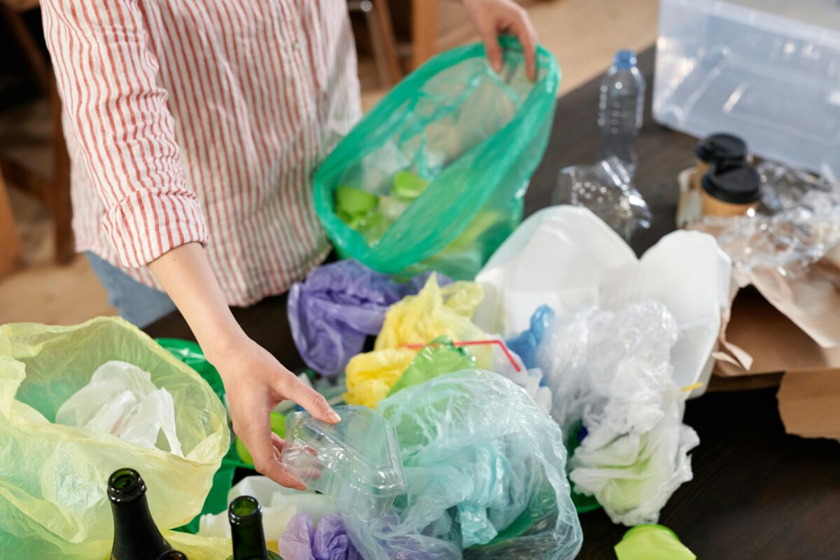 A Person Sorting Plastic Wastes