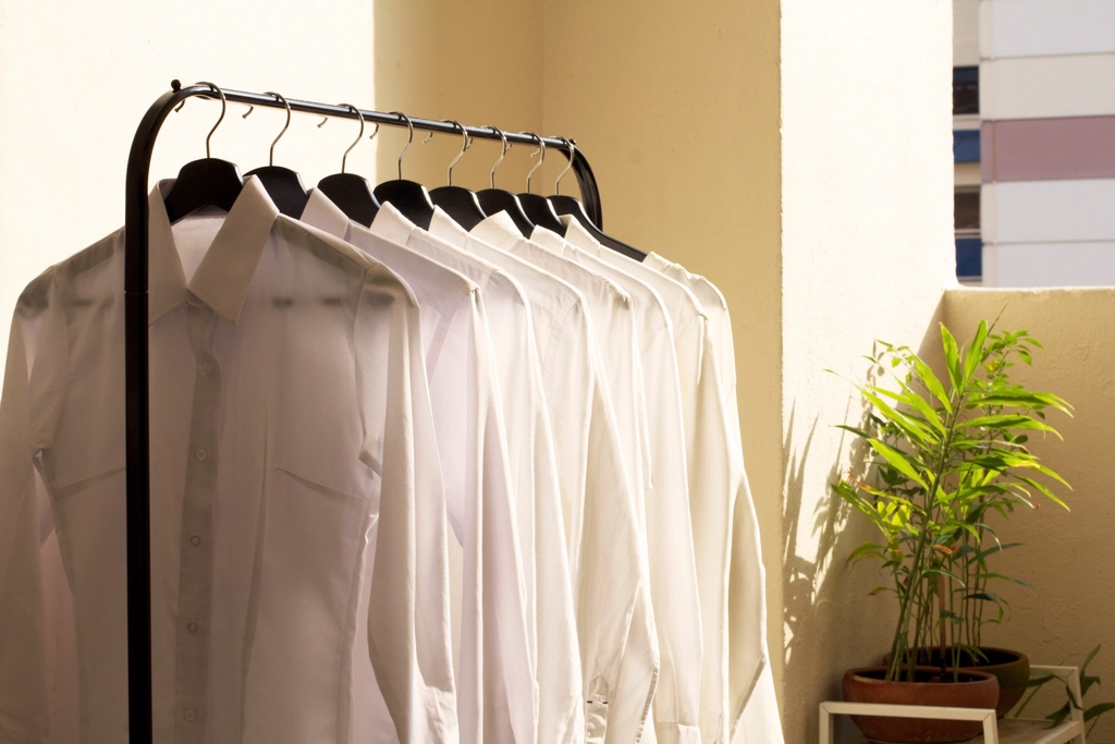 Minimal capsule wardrobe with coordinated clothes on a rail