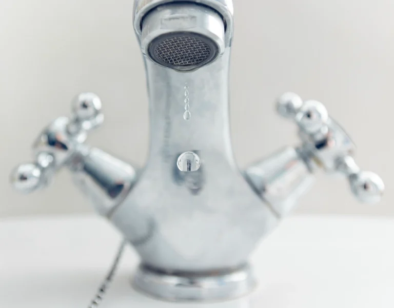Water running from a faucet, representing household water footprint