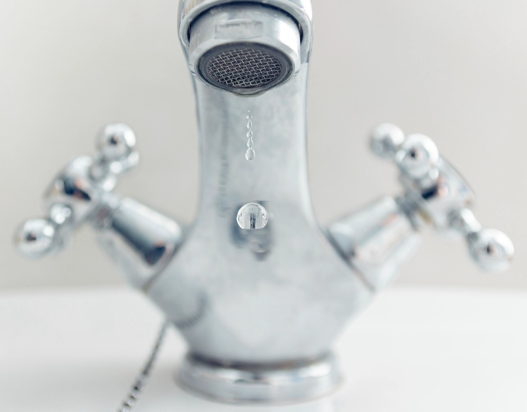 Water running from a faucet, representing household water footprint